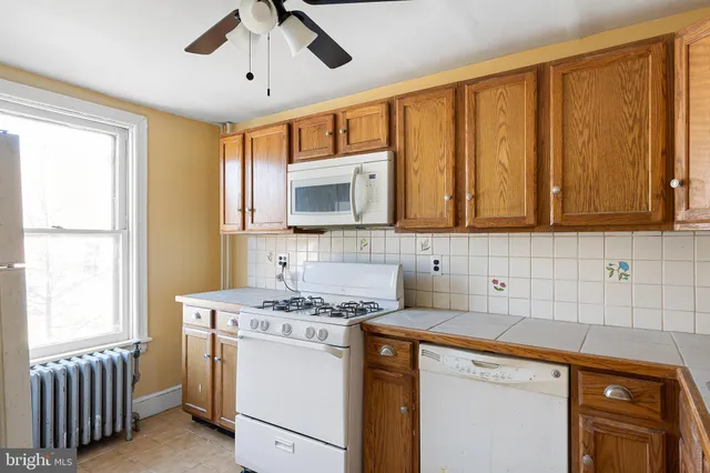 a kitchen with stainless steel appliances granite countertop a sink stove and microwave