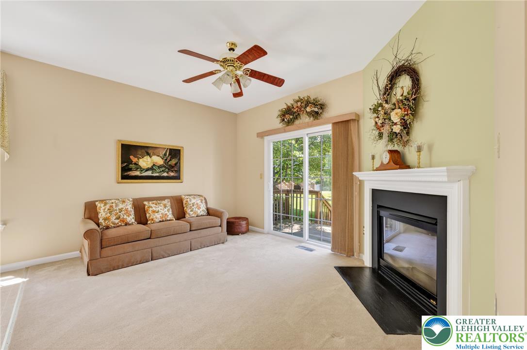 4345 Creek Road Allentown, PA 18104 - Photo 12 of 33 A well-lit gathering space features a charming fireplace and convenient patio access.