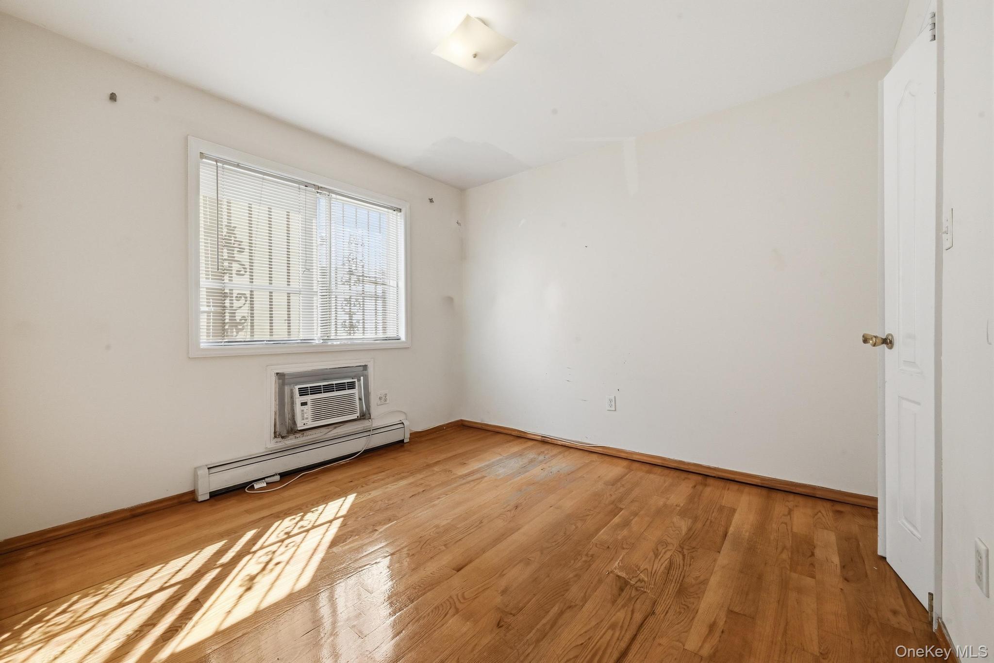 61-16 161 Street Queens, NY 11365 - Photo 11 of 22 a view of an empty room with a window