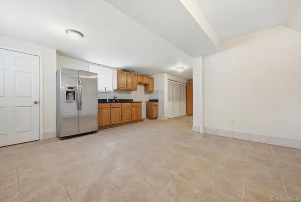 a view of a big room with refrigerator a kitchen and a sink