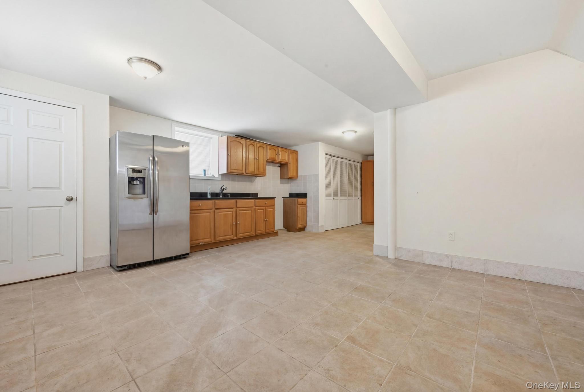 61-16 161 Street Queens, NY 11365 - Photo 16 of 22 a view of a big room with refrigerator a kitchen and a sink