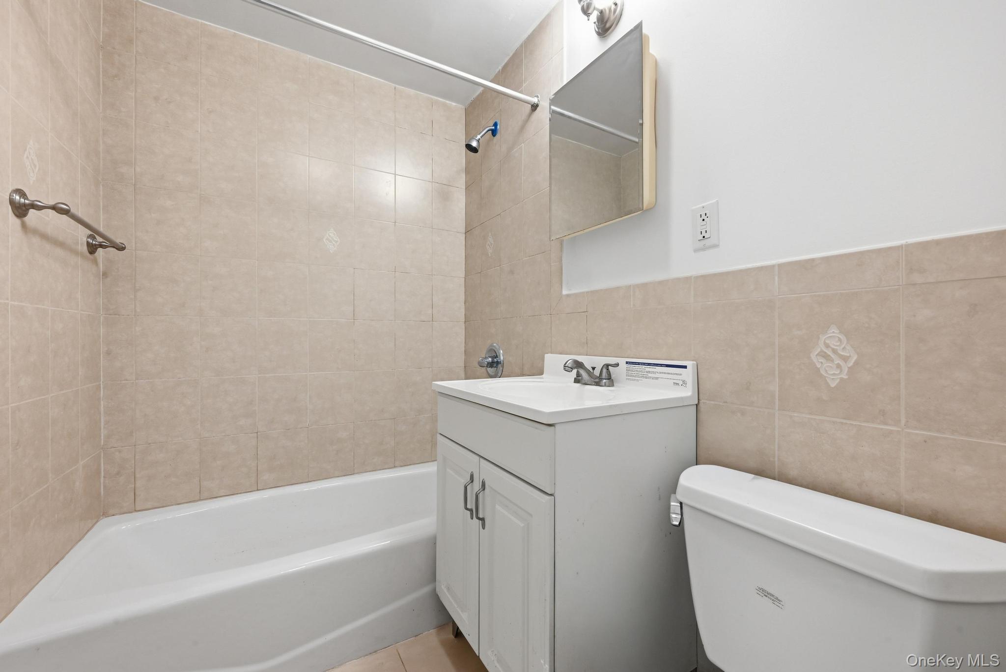 61-16 161 Street Queens, NY 11365 - Photo 21 of 22 a view of bathroom with a sink and mirror with toilet