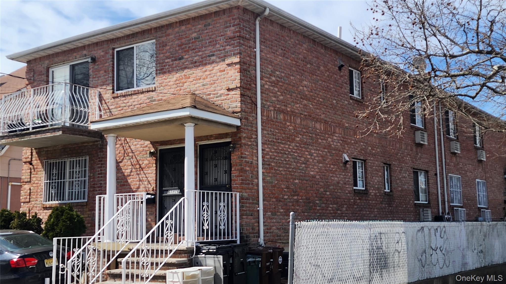 61-16 161 Street Queens, NY 11365 - Photo 3 of 22 front view of a brick house with a large windows