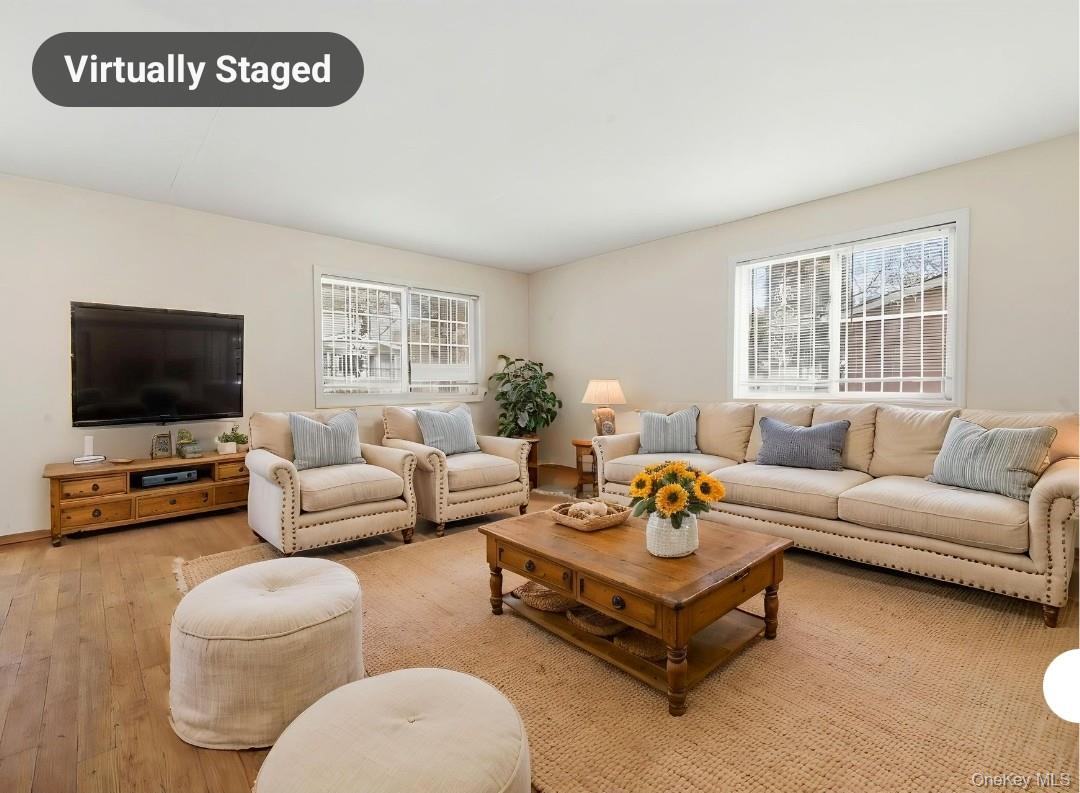61-16 161 Street Queens, NY 11365 - Photo 5 of 22 a living room with furniture and a flat screen tv