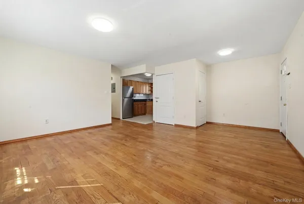 a view of empty room with wooden floor