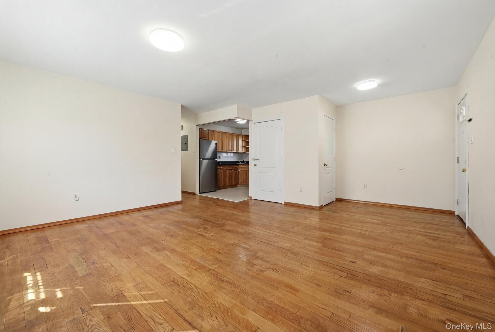 61-16 161 Street Queens, NY 11365 - Photo 7 of 22 a view of empty room with wooden floor