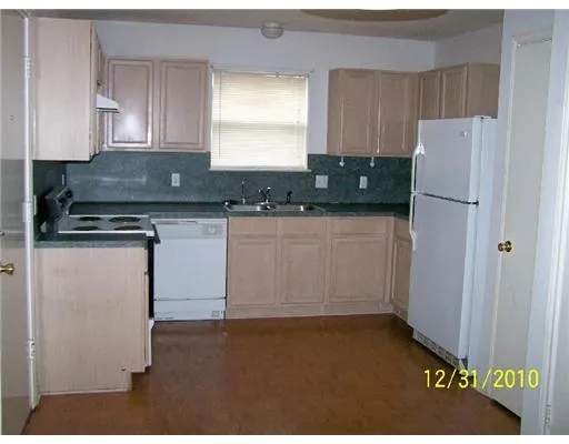 a kitchen with a refrigerator and cabinets