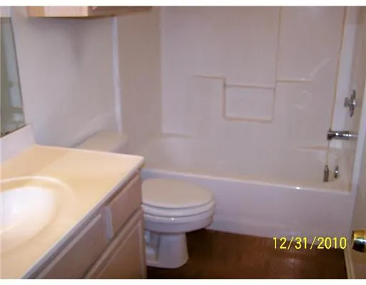 a bathroom with a sink a toilet and bathtub