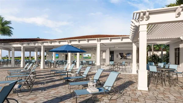 a view of a patio with table and chairs under an umbrella