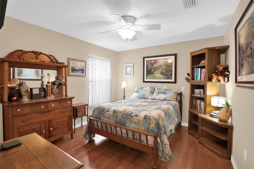 16411 Southwest 14th Avenue Road Ocala, FL 34473 - Photo 20 of 59 a bedroom with a bed and a mirror on dresser