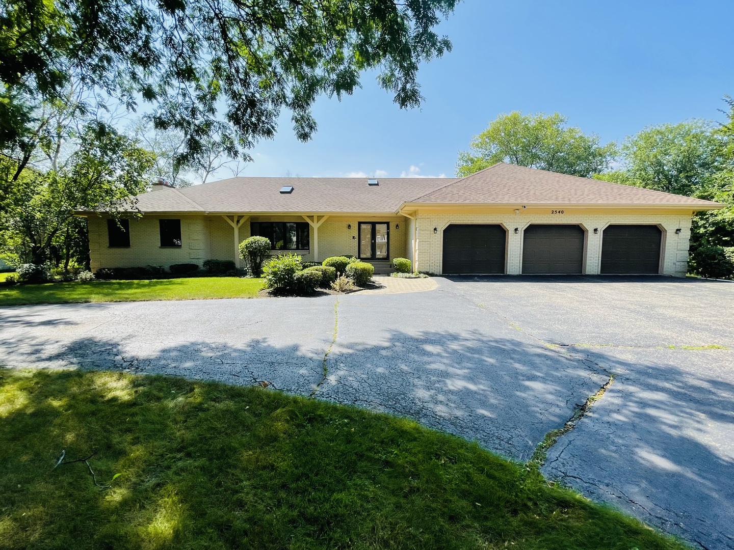 2540 Highmoor Road Highland Park, IL 60035 - Photo 1 of 1 a front view of a house with a yard and garage