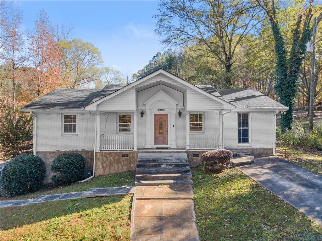 3200 Stonewall Tell Road Atlanta, GA 30349 - Photo 1 of 1 a front view of a house with a yard