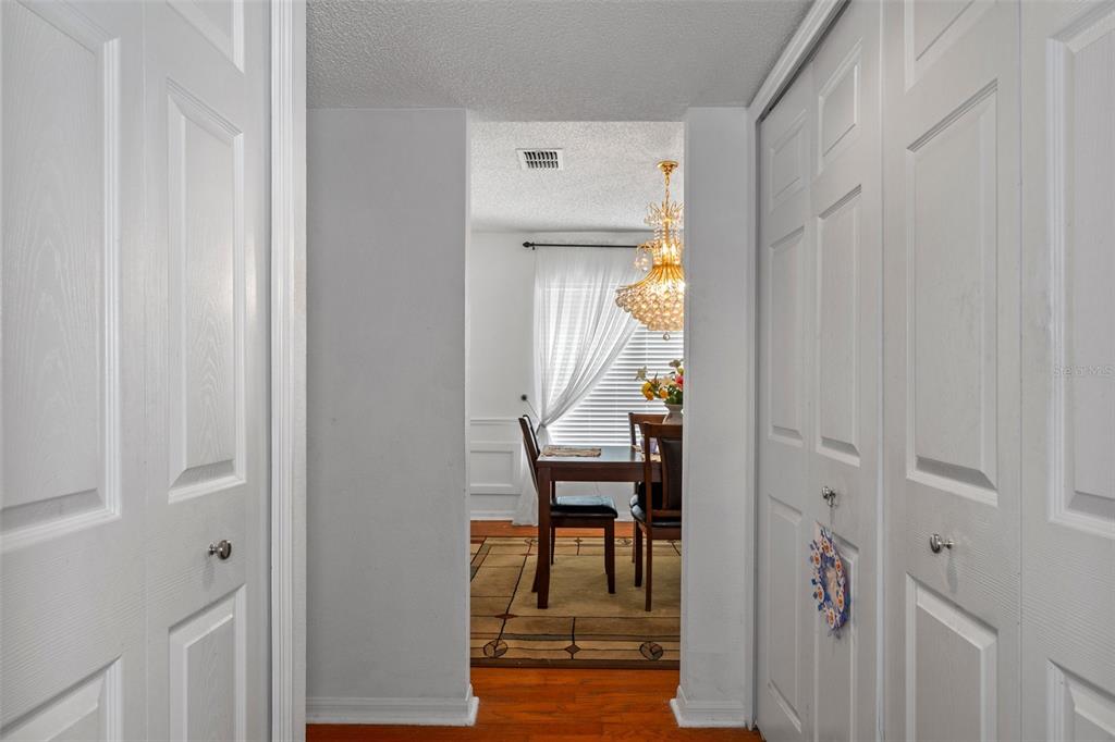 10331 Dunkirk Road Spring Hill, FL 34608 - Photo 14 of 42 a view of a hallway with wooden floor and a dining room