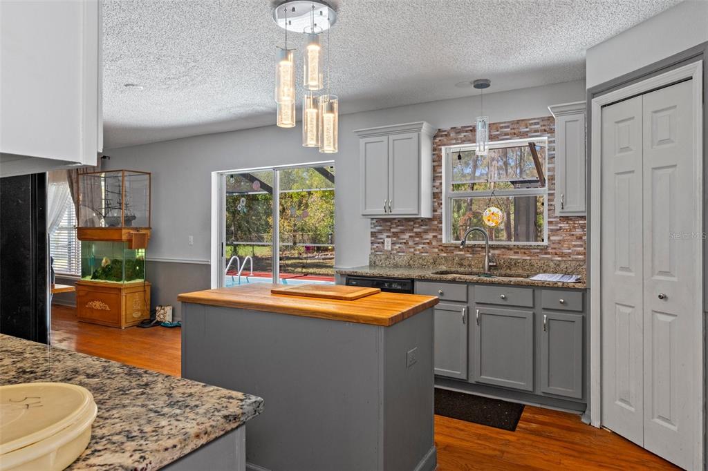 10331 Dunkirk Road Spring Hill, FL 34608 - Photo 17 of 42 a kitchen with stainless steel appliances granite countertop sink stove and refrigerator