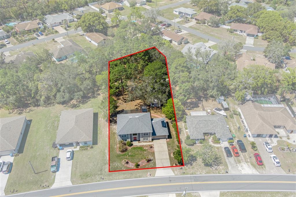 10331 Dunkirk Road Spring Hill, FL 34608 - Photo 3 of 42 an aerial view of residential houses with outdoor space