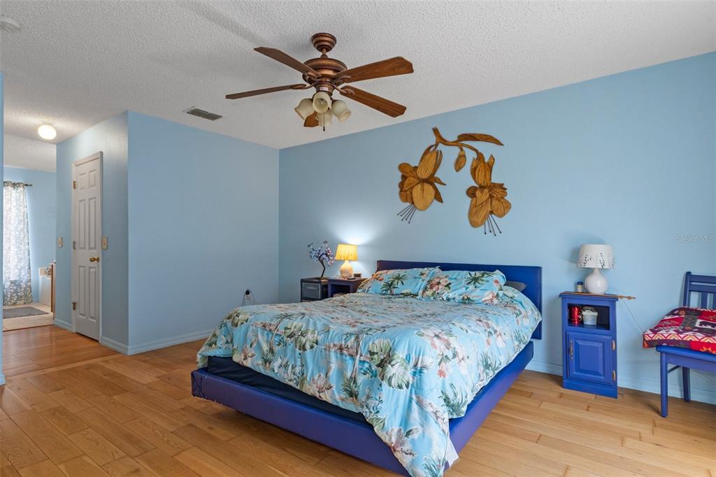 10331 Dunkirk Road Spring Hill, FL 34608 - Photo 36 of 42 a bedroom with a bed and painting on the wall