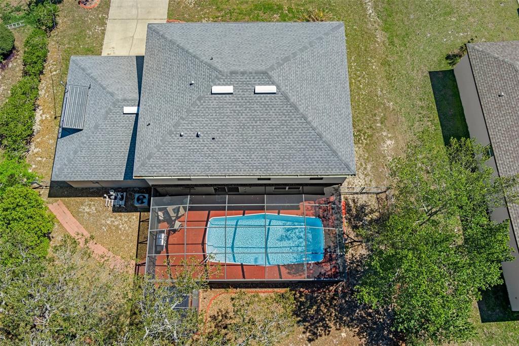 10331 Dunkirk Road Spring Hill, FL 34608 - Photo 5 of 42 an aerial view of a house with swimming pool and large trees