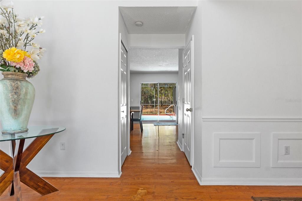 10331 Dunkirk Road Spring Hill, FL 34608 - Photo 7 of 42 a view of a hallway view with wooden floor and staircase