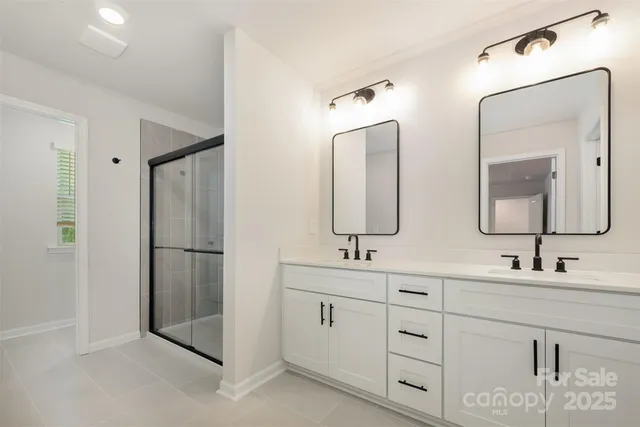 a bathroom with a double vanity sink and mirror
