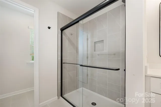 a bathroom with a glass shower door
