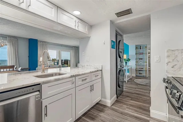 a en suite bathroom with a granite countertop sink and a mirror