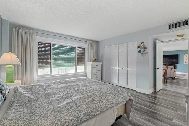 a bedroom with a bed and a large window