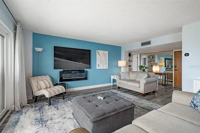 a living room with furniture a rug and a flat screen tv