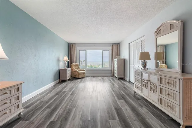 a view of a room with wooden floor and windows