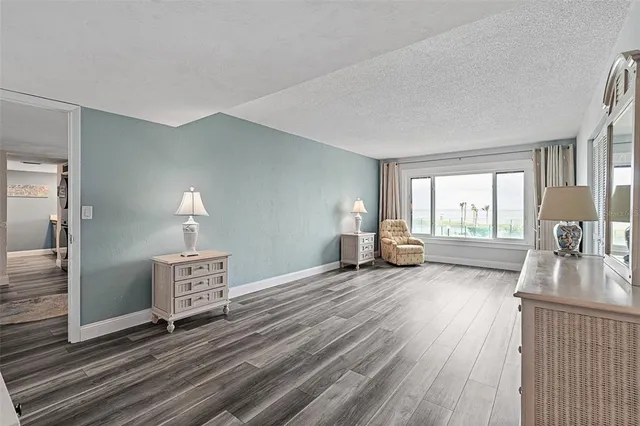 a view of a livingroom with wooden floor and a flat screen tv