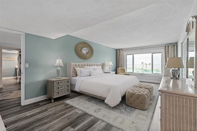 a bedroom with a bed and a large window