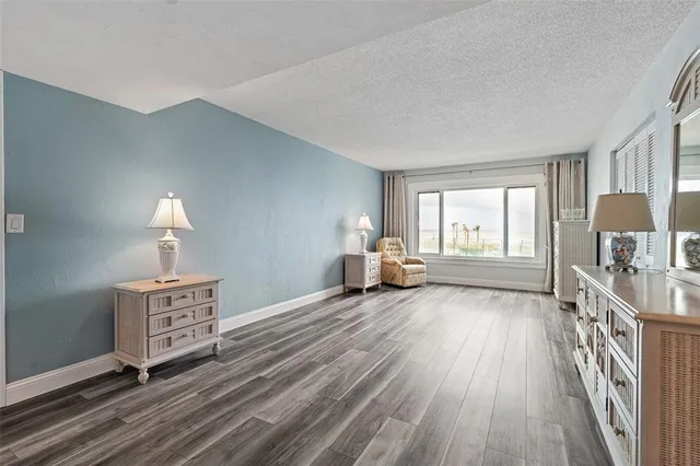 a living room with furniture a window and a lamp