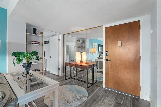 a view of a livingroom with furniture and a table in it
