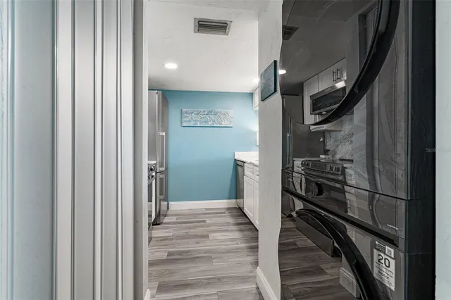 a kitchen with a refrigerator and stove