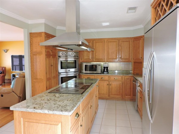 63 Colonial Road Webster, MA 01570 - Photo 8 of 30 a kitchen with stainless steel appliances granite countertop a sink and refrigerator