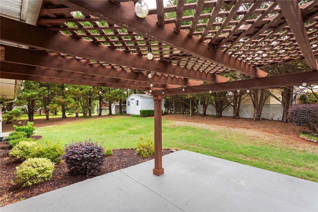 202 Keowee Trail Seneca, SC 29672 - Photo 32 of 35 This spacious yard features a pergola, patio, and shed, offering abundant outdoor living potential.