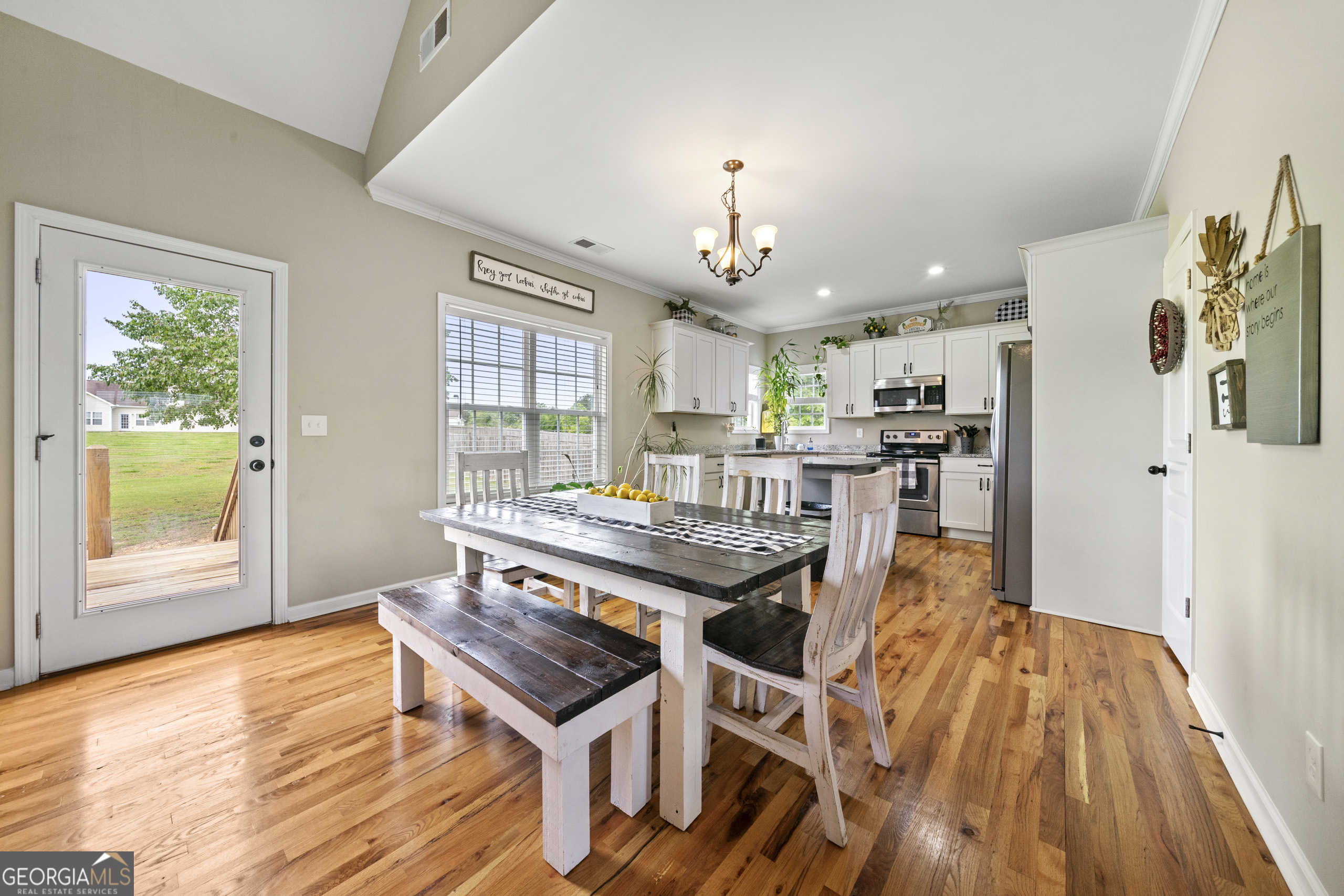 304 Kodiak Road Carrollton, GA 30117 - Photo 15 of 36 a living room with stainless steel appliances kitchen island granite countertop furniture and a wooden floor