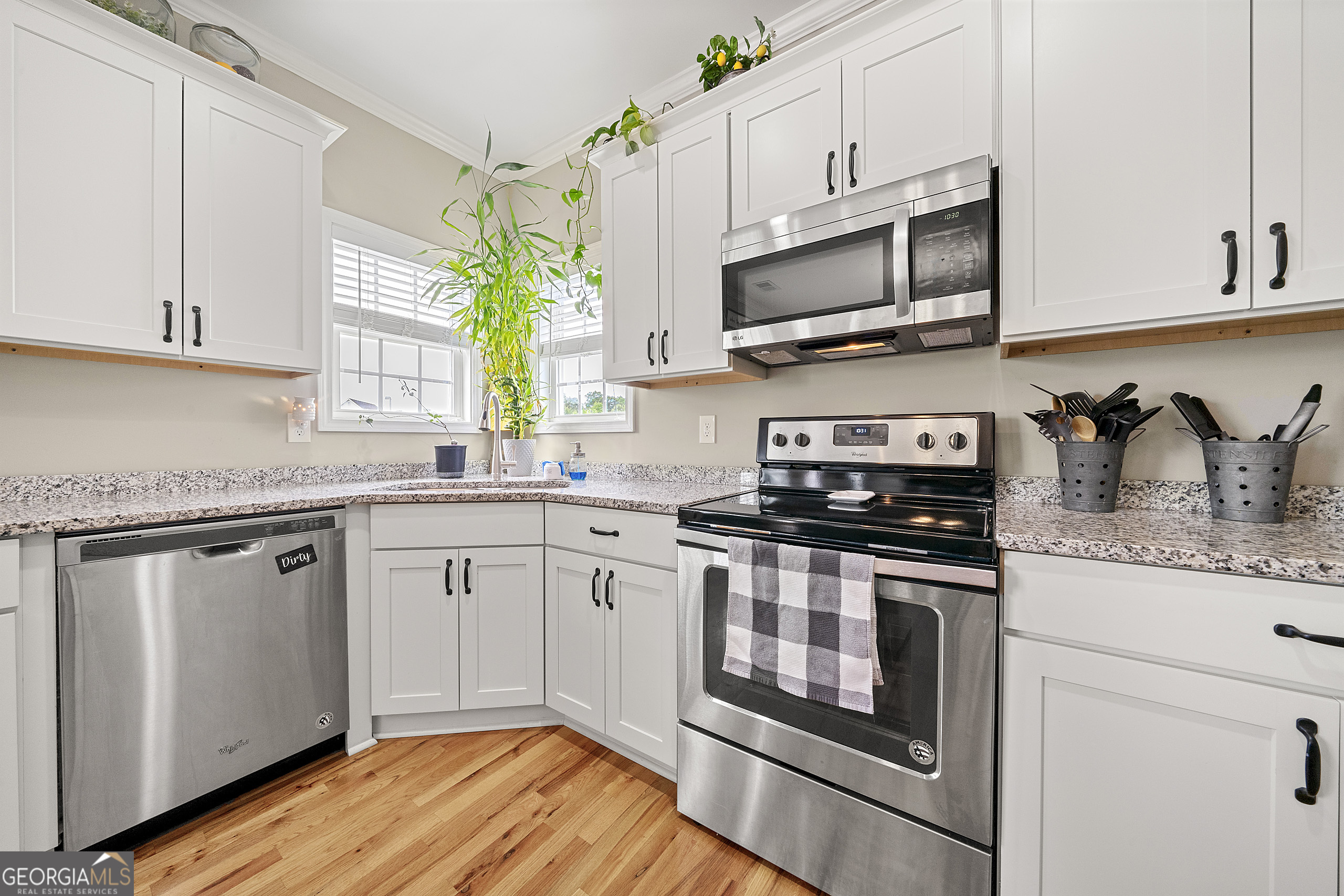 304 Kodiak Road Carrollton, GA 30117 - Photo 17 of 36 a kitchen with stainless steel appliances granite countertop a sink a stove a microwave and cabinets
