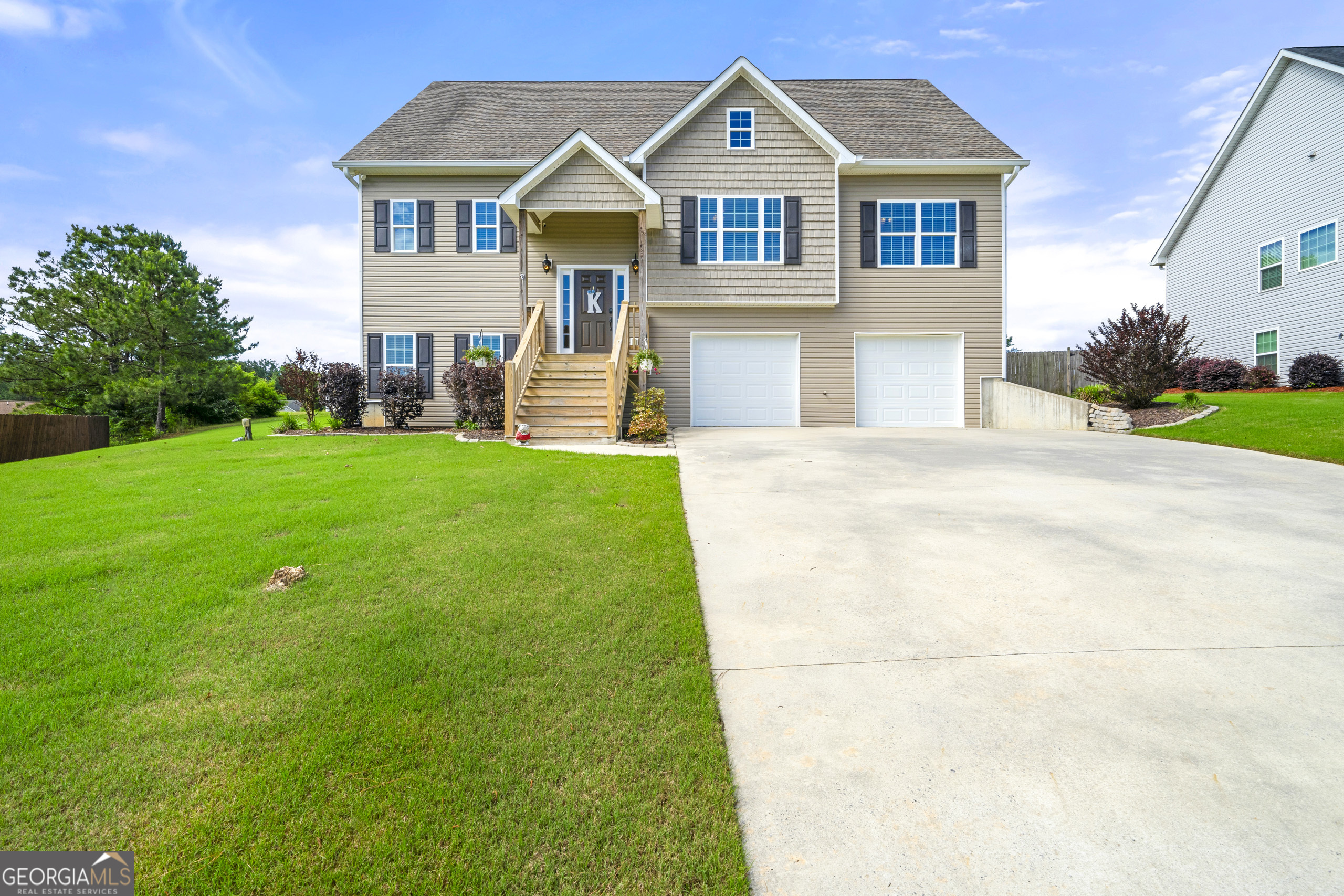 304 Kodiak Road Carrollton, GA 30117 - Photo 2 of 36 a front view of a house with a yard and garage