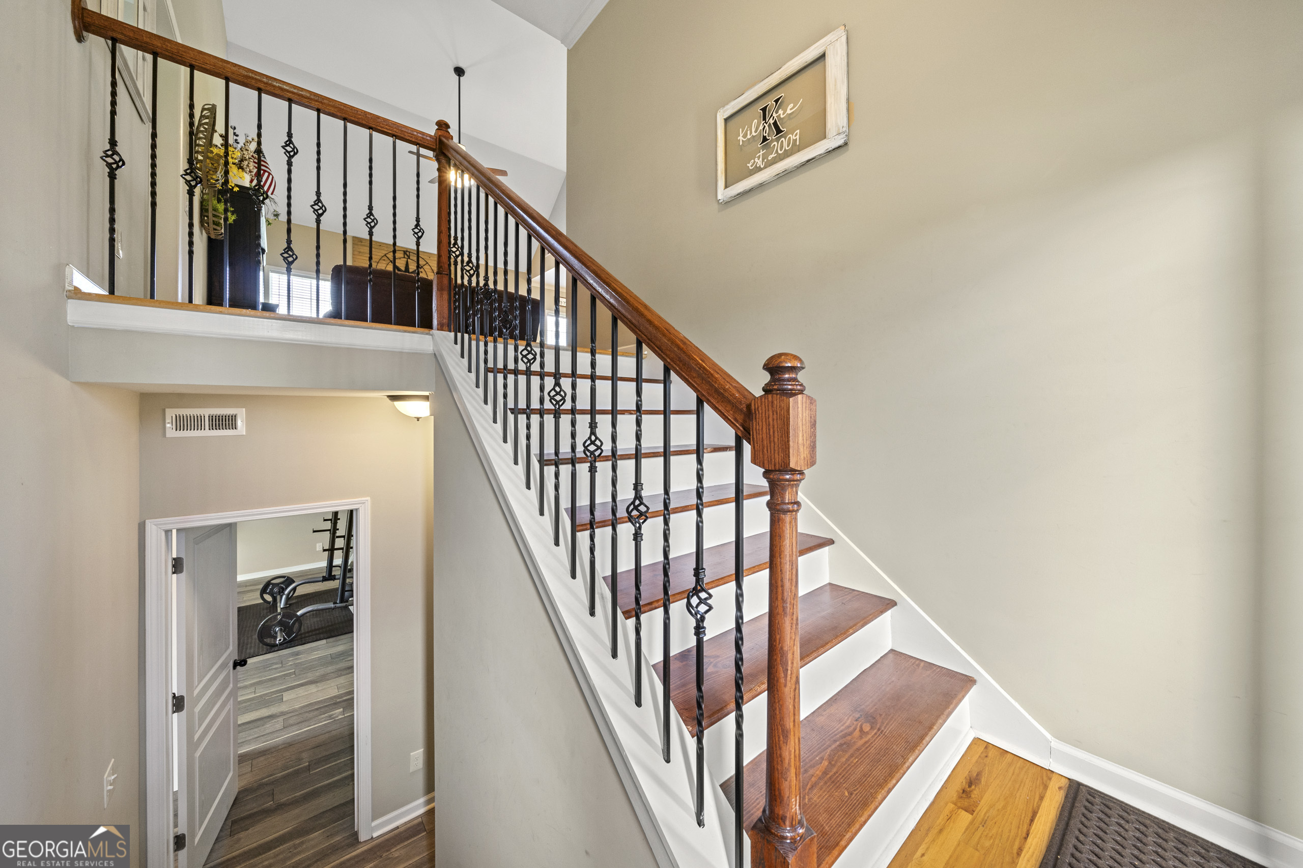 304 Kodiak Road Carrollton, GA 30117 - Photo 9 of 36 a view of staircase with wooden floor and white walls
