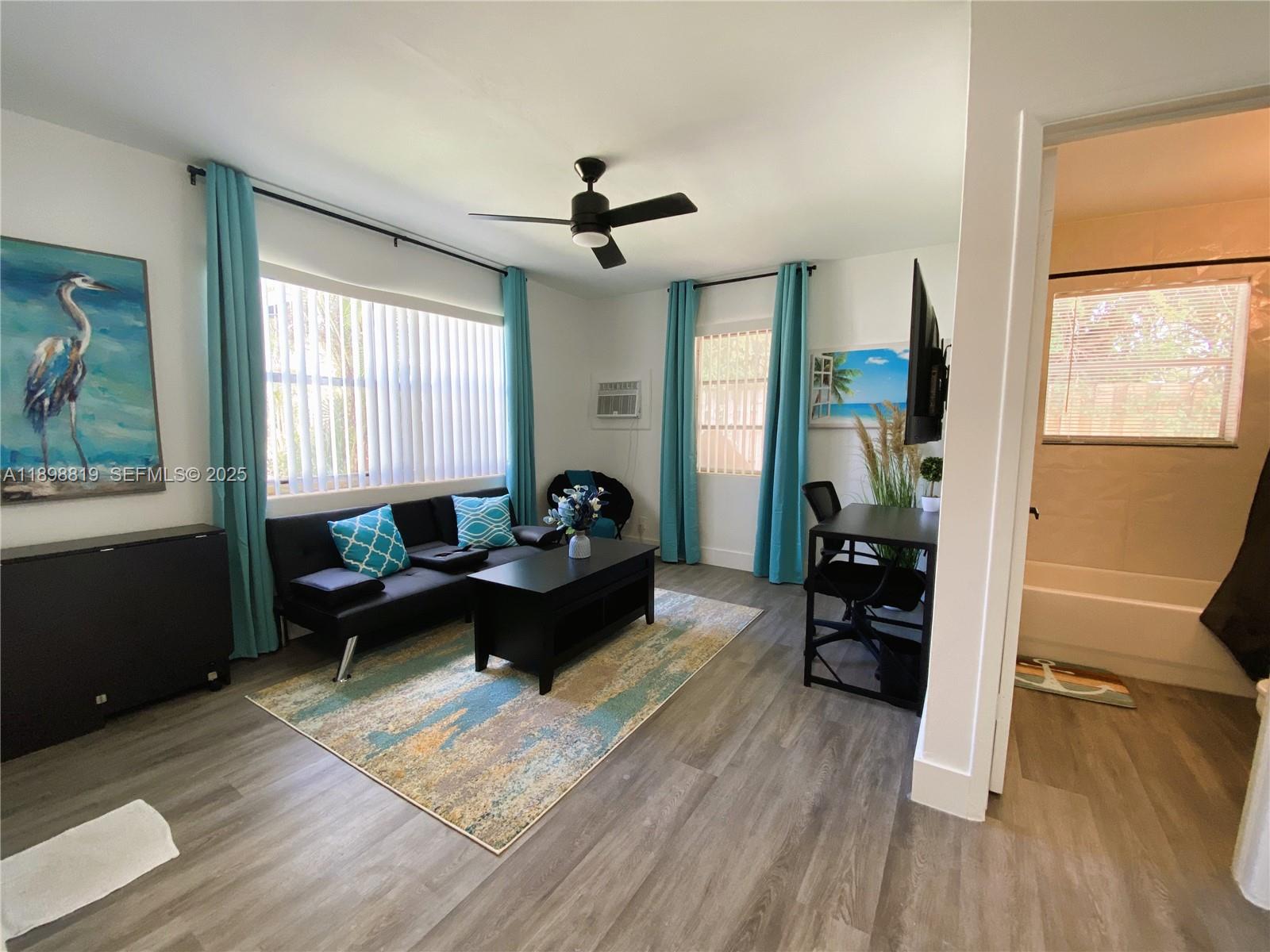 3208 Canal Drive, Unit 4 Pompano Beach, FL 33062 - Photo 12 of 15 a living room with furniture and a hard wood floor