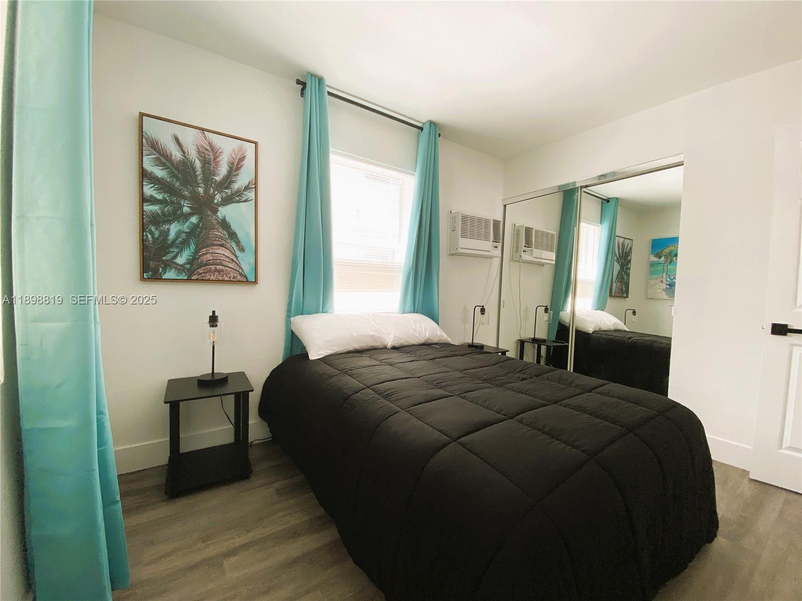 3208 Canal Drive, Unit 4 Pompano Beach, FL 33062 - Photo 15 of 15 a bedroom with a bed and a painting on the wall