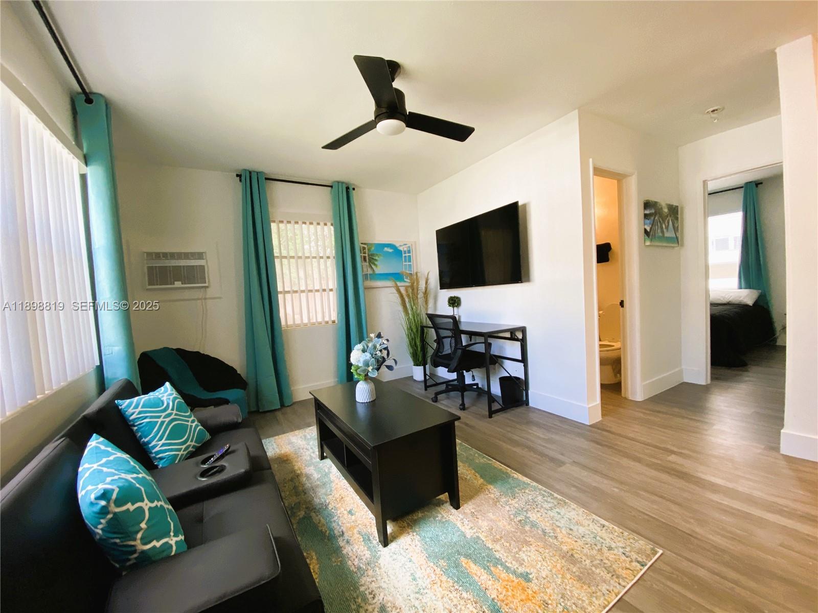 3208 Canal Drive, Unit 4 Pompano Beach, FL 33062 - Photo 6 of 15 a living room with furniture and a flat screen tv