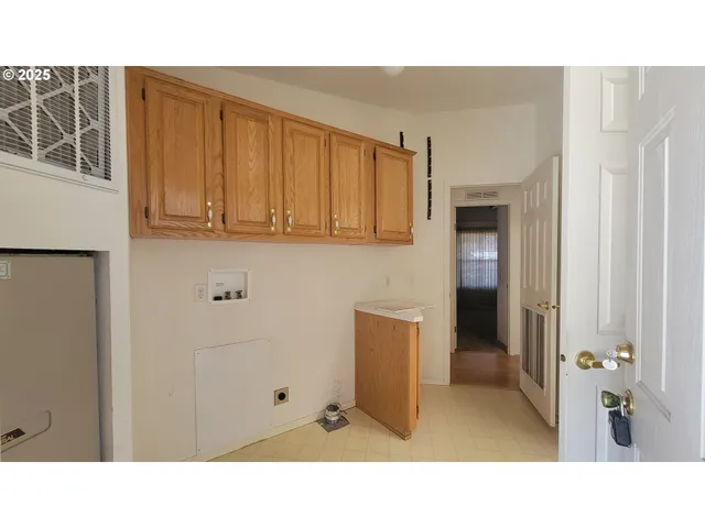 a open kitchen with sink and cabinets
