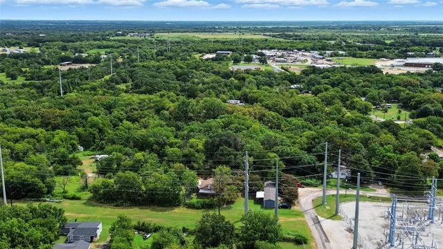 a view of a city with lush green forest