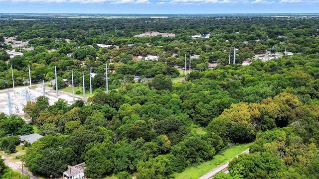 a view of a lush green field with a houses