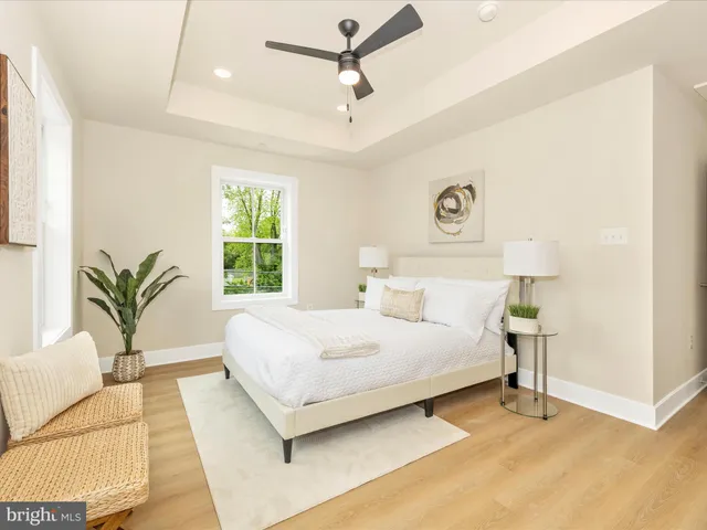 a bedroom with a bed and table chair