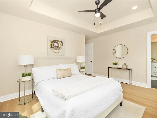 a bedroom with a large bed and potted plant