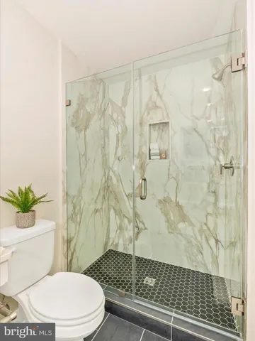 a white toilet sitting next to a bathroom sink