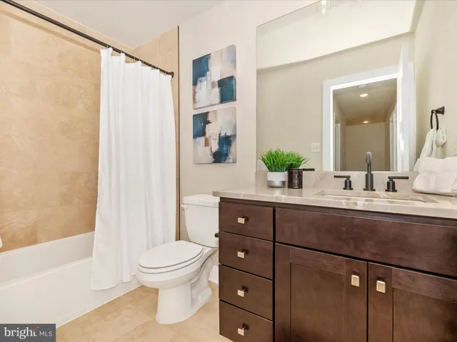 a bathroom with a double vanity sink toilet and shower