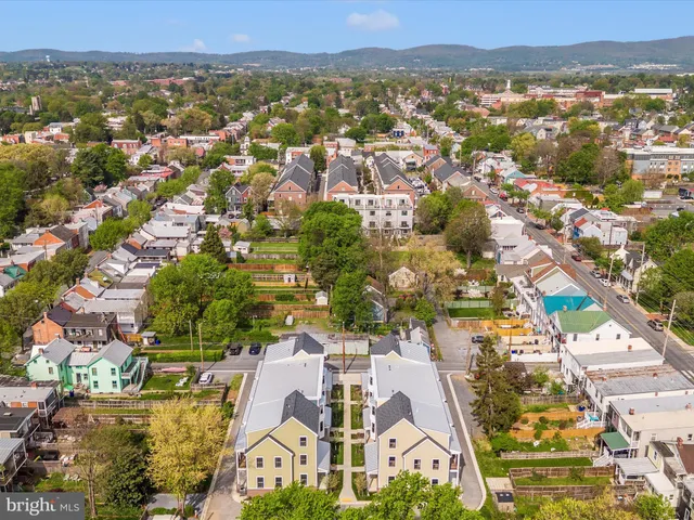 an aerial view of residential houses with outdoor space
